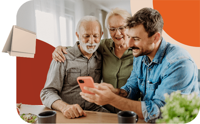 Three people looking at a phone and smiling