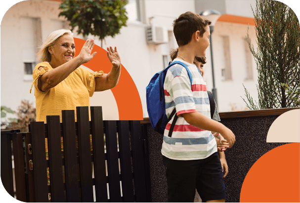 Mom waving goodbye to kids on their way to school